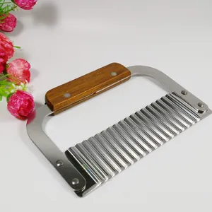 Close-up detail view of a professional stainless steel crinkle cutter with wooden handle