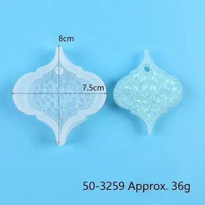 Close-up of silicone resin mold with finished glittery pendant and dimensions