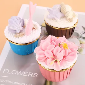 Detail view of colorful muffin liners with decorative cupcake toppers