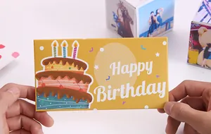 Close-up of yellow Happy Birthday jumping box gift box with cake design