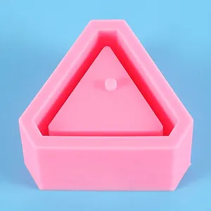 Detailed macro view of a pink geometric triangle silicone mold for DIY succulent pots.