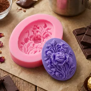 Detail macro view of oval rose silicone mold with finished purple floral chocolate