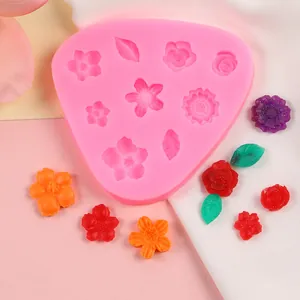 Detailed view of pink flower silicone mold with colorful DIY fondant creations.