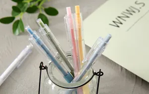Detailansicht farbiger Gelschreiber in einem Glas im minimalistischen Design.