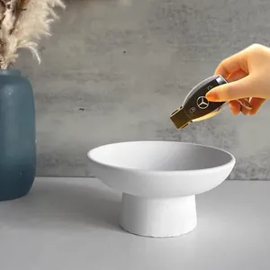 Detailed view of white minimalist pedestal tray for key storage or home decor