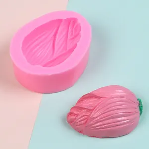 Detail view of pink silicone mold with finished flower bud shaped fondant model