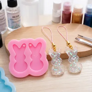Close-up of double bunny silicone mold with finished sparkling glitter resin charms