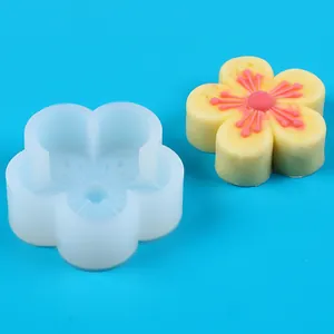 Detailed macro view of cherry blossom silicone mold with a finished yellow flower cake