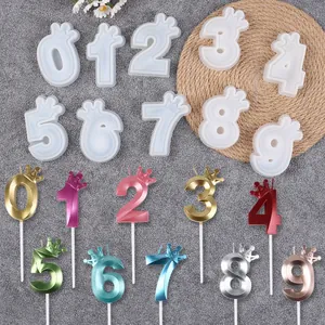 Detailed view of crown number birthday candles and matching silicone molds for cake decorating