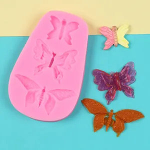 Detailed macro view of 3-cavity butterfly silicone mold with colorful finished samples