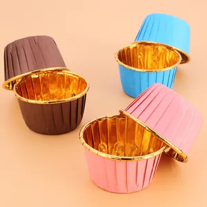 Close-up of assorted colorful muffin liners with a reflective gold foil interior coating