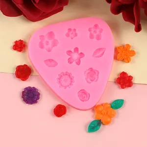 Detail view of pink silicone mold with various floral and leaf shapes for DIY baking