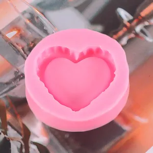 Primo piano di uno stampo in silicone rosa a forma di cuore con bordi ondulati per fai da te