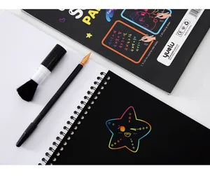 Detailed view of DIY scratch art coil notebook set with wooden stylus and cleaning brush