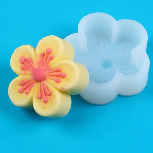 Sakura cherry blossom silicone mold shown with a finished yellow and pink wax flower sample