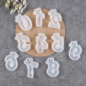 Top-down view of white silicone crown number molds for birthday cake and candle decorating