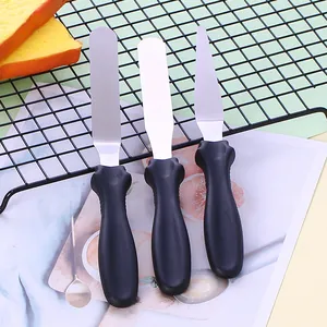Detailed view of a 3-piece stainless steel baking spatula set with ergonomic black handles