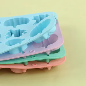 Macro detail showing the multi-layered texture of colorful silicone pumpkin baking molds.