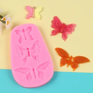 Detailed view of pink butterfly silicone mold with finished decorative butterfly shapes