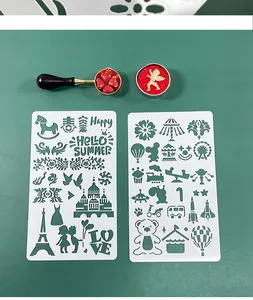 Close-up of hollowed-out DIY drawing stencils with icons and matching wax seal spoon set