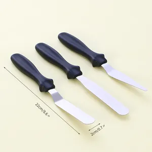 Close-up detail of three-piece stainless steel cake spatulas with clear size markings