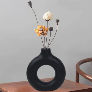 Minimalist black doughnut plastic vase with a matte imitation ceramic finish for home decor