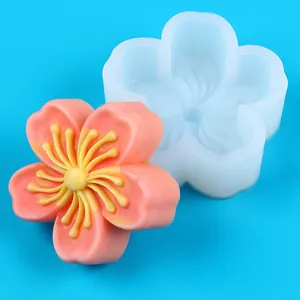 Detailed close-up of a sakura flower silicone mold alongside a finished pink blossom