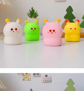 A detailed view showing four colorful and cute cartoon squishy stress relief toys on a table