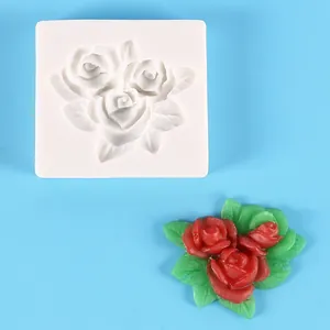 Silicone rose flower mold with finished red rose fondant sample on blue background