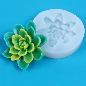 Detailed view of a 3D succulent silicone mold with finished green soap flower on blue background