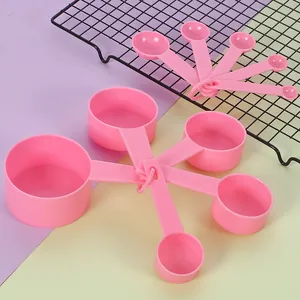 Detail view of 10pcs pink plastic measuring spoons and cups set with embossed scales