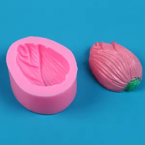Detail showing a pink silicone mold with its 3D flower bud shaped finished craft product