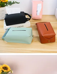 Detailed shot of portable leather tissue boxes in various colors with hanging straps
