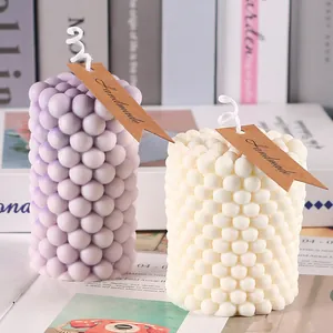 Detailed view of artisanal handmade purple and white bubble candles for home fragrance decor