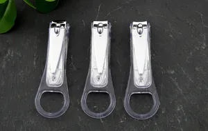 Dettaglio di tre tagliaunghie minimalisti con paraspruzzi su fondo in ardesia.