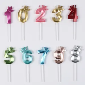 Detailed view of colorful 0-9 number candles with crown toppers for birthday cake