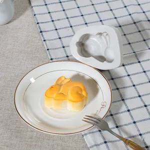 Rabbit shaped silicone cake mold with mooncake product on a white plate