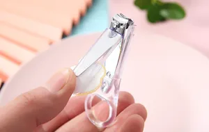 Detailed macro shot of a transparent nail clipper featuring a cute cartoon bear decoration