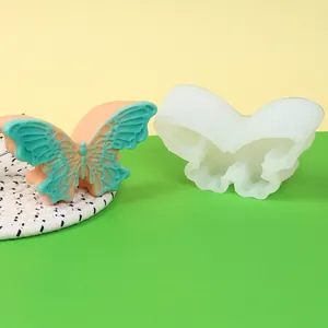 Vista detallada del molde de silicona de mariposa con un jabón de cera colorido.
