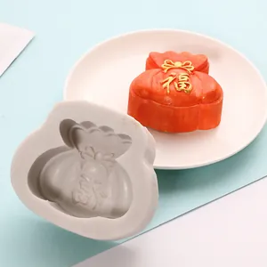 Lucky bag silicone mold showing the grey mold and a finished orange cake detail