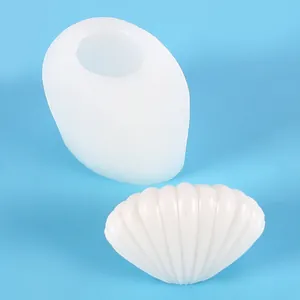 Detail view of a shell-shaped silicone mold with its white finished product.