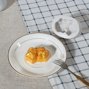 Detail view of a goldfish-shaped silicone mold alongside a finished golden cake dessert