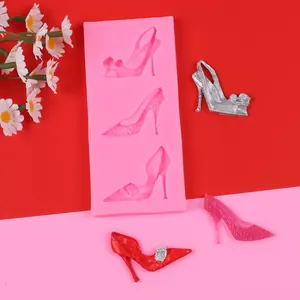 Detail of pink silicone mold with high heel shapes and sample fondant cake decorations