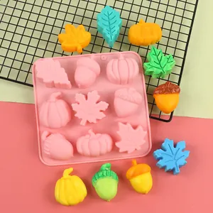 Detailed view of 9-cavity pumpkin acorn maple leaf silicone mold with colorful finished items