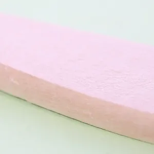 Detailed close-up macro view of a pink wooden brush handle with fine grain texture