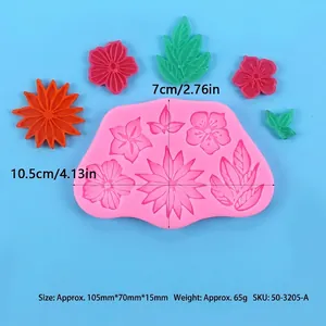 Macro view of a pink silicone mold showing various flower and leaf patterns with sizes