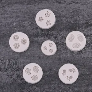 Macro detail of various floral silicone fondant molds with rose and daisy patterns