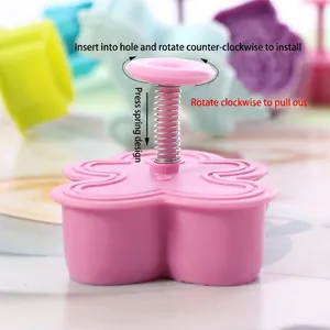 Pink flower-shaped spring-press cookie mold tool for DIY baking and fondant shaping