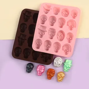 Macro detail of Halloween skull silicone mold with various finished candy skulls on lavender background