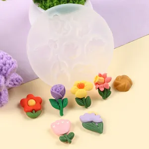 Macro detail view of floral silicone mold with colorful handmade flower fondant shapes